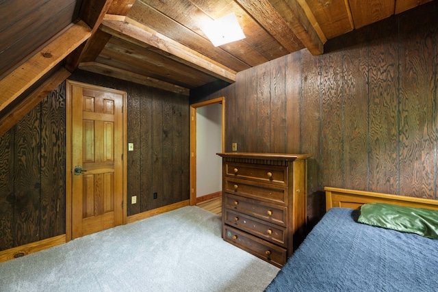 carpeted bedroom featuring wooden walls, beamed ceiling, and wooden ceiling