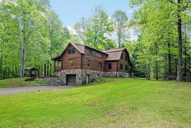 view of home's exterior featuring an attached garage, a lawn, a chimney, a gazebo, and driveway
