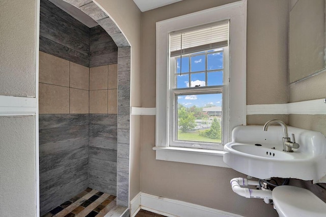bathroom featuring a sink and tiled shower