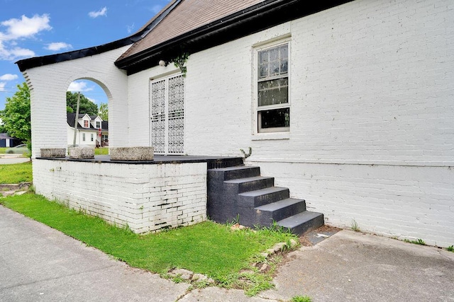 view of property exterior with brick siding