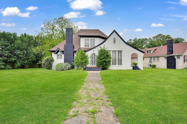 view of front facade with a front lawn and a chimney