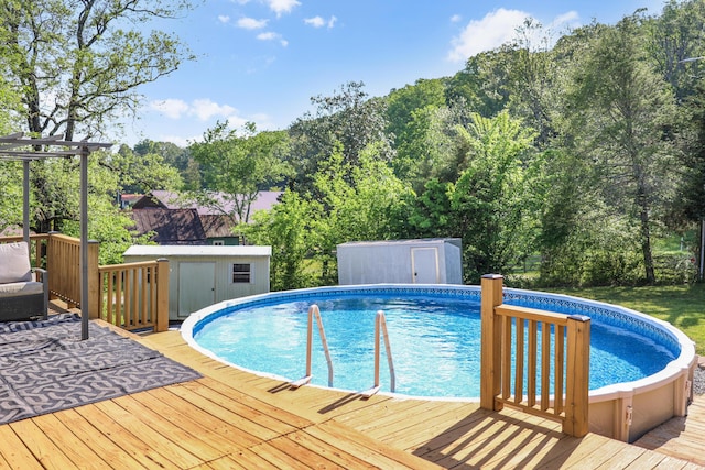 pool with a wooden deck, an outdoor structure, and a shed