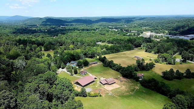 drone / aerial view featuring a forest view