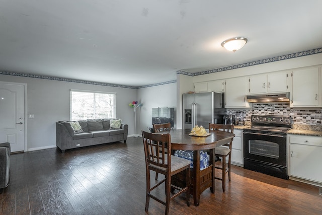 dining space with dark wood-style flooring and baseboards