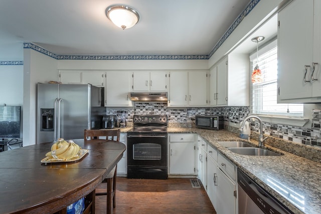 kitchen featuring a sink, black appliances, dark wood finished floors, under cabinet range hood, and white cabinets