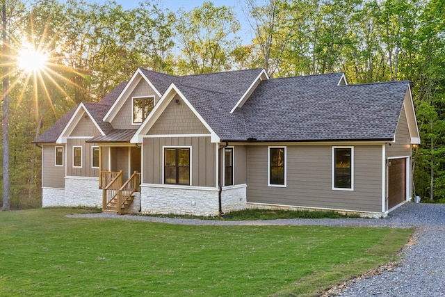 490 Moonlight Ln, Jasper, TN 37347 - view of front of house with board and batten siding, a front lawn, roof with shingles, stone siding, and driveway