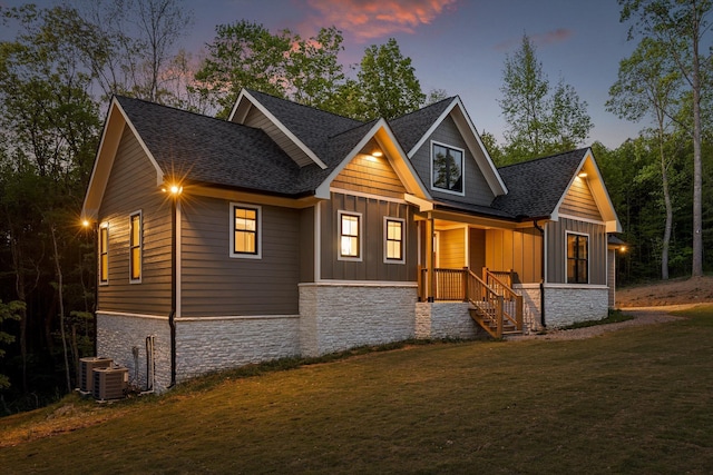 490 Moonlight Ln, Jasper, TN 37347 - view of front of home with stone siding, board and batten siding, roof with shingles, a front lawn, and covered porch