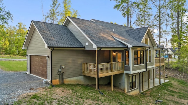 490 Moonlight Ln, Jasper, TN 37347 - back of house featuring roof with shingles, a garage, driveway, a lawn, and a wooden deck