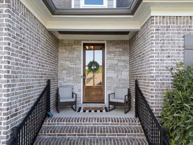 view of exterior entry featuring a porch and brick siding