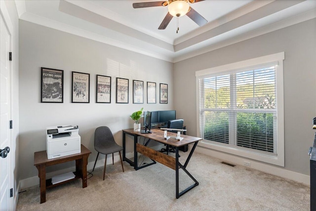 office area with visible vents, a ceiling fan, a raised ceiling, and carpet floors