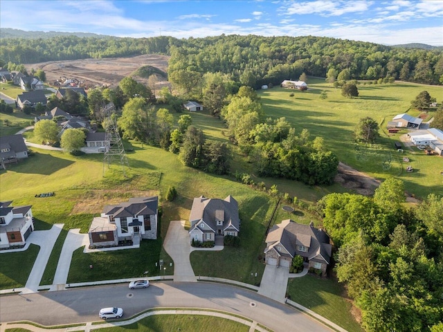 drone / aerial view with a residential view and a wooded view
