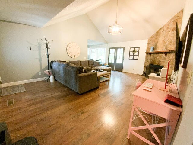 8721 Forest Pond Dr, Harrison, TN 37341 - living area with wood finished floors, a fireplace, baseboards, high vaulted ceiling, and french doors