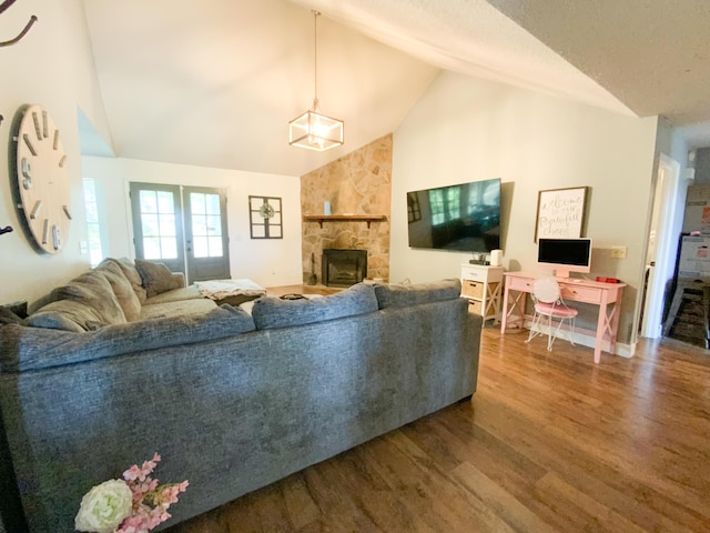 8721 Forest Pond Dr, Harrison, TN 37341 - living room featuring high vaulted ceiling, a stone fireplace, and wood finished floors