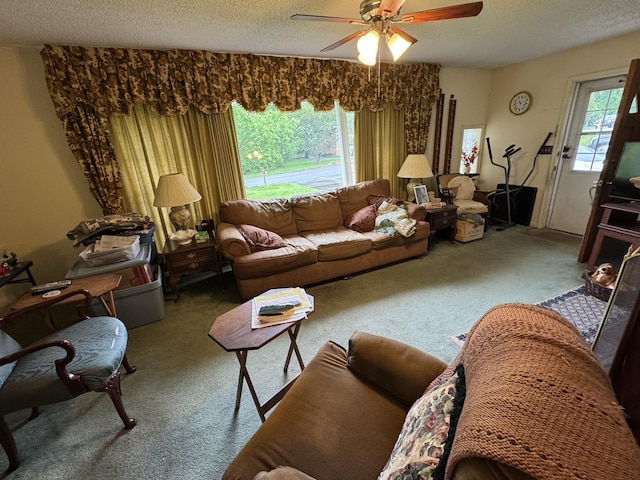 living area featuring carpet flooring, a textured ceiling, and ceiling fan