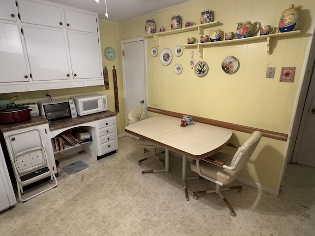 office featuring light floors and a toaster