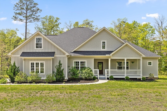 craftsman-style house featuring a shingled roof, board and batten siding, a porch, and a front lawn