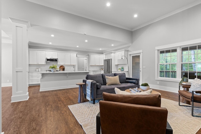 living area featuring crown molding, recessed lighting, baseboards, and dark wood finished floors