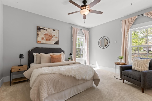 carpeted bedroom featuring baseboards and ceiling fan