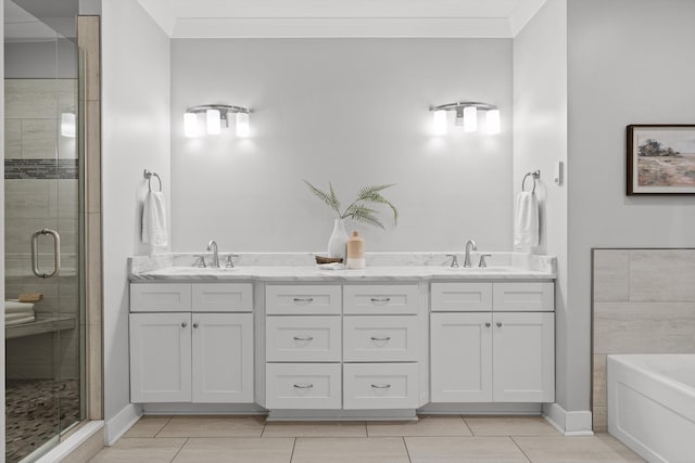 bathroom with double vanity, a sink, a bath, and a stall shower