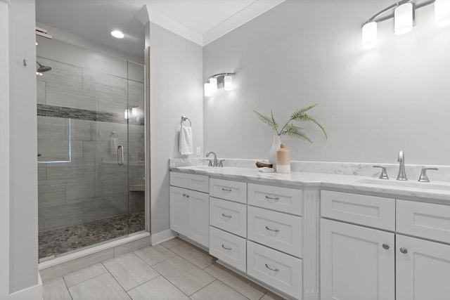full bathroom featuring crown molding, tile patterned floors, a shower stall, and a sink