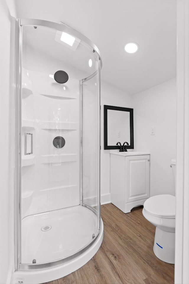 2917 Crescent Cir, Chattanooga, TN 37407 - bathroom with wood finished floors, a stall shower, toilet, and vanity