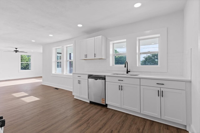 2917 Crescent Cir, Chattanooga, TN 37407 - kitchen with dark wood-style flooring, a sink, dishwasher, light countertops, and decorative backsplash