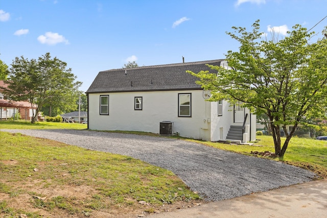 2917 Crescent Cir, Chattanooga, TN 37407 - exterior space with central air condition unit, a shingled roof, a yard, and stucco siding