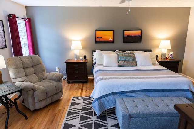 bedroom featuring baseboards and wood finished floors
