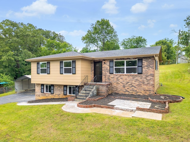 1852 N Prairie Cir, Hixson, TN 37343 - view of front facade featuring brick siding, a front lawn, a detached carport, and driveway