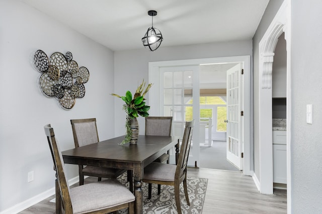1852 N Prairie Cir, Hixson, TN 37343 - dining room featuring light wood finished floors, baseboards, arched walkways, and french doors