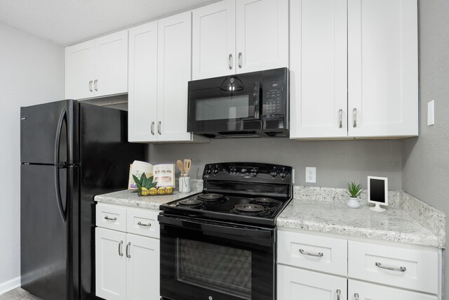 1852 N Prairie Cir, Hixson, TN 37343 - kitchen with black appliances, white cabinetry, and light stone countertops