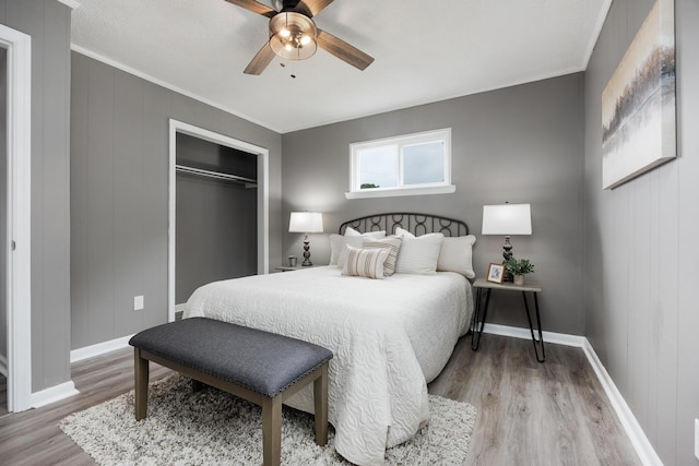 1852 N Prairie Cir, Hixson, TN 37343 - bedroom with light wood finished floors, baseboards, ornamental molding, a closet, and ceiling fan
