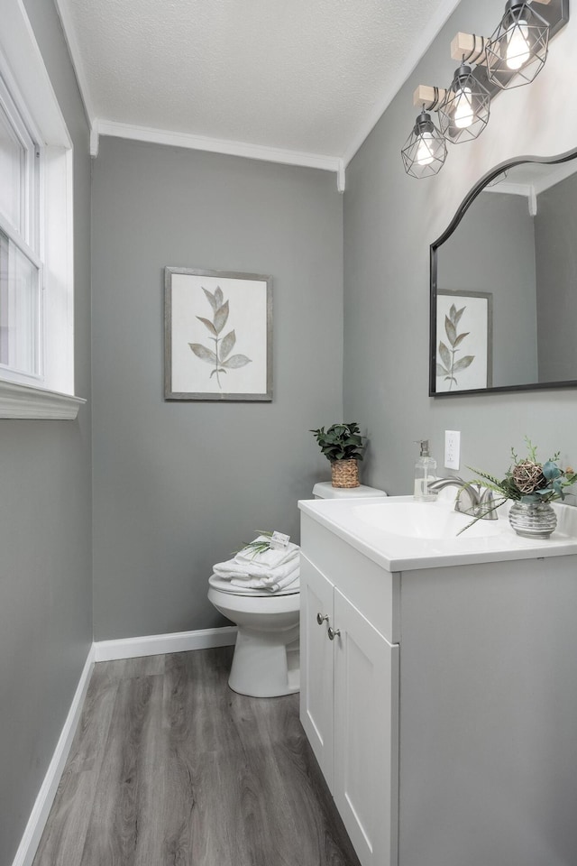 1852 N Prairie Cir, Hixson, TN 37343 - bathroom with wood finished floors, toilet, vanity, baseboards, and crown molding