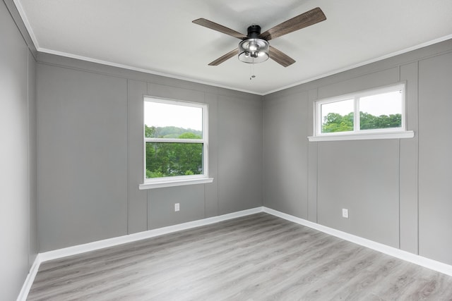 1852 N Prairie Cir, Hixson, TN 37343 - unfurnished room with ornamental molding, wood finished floors, a ceiling fan, baseboards, and a decorative wall