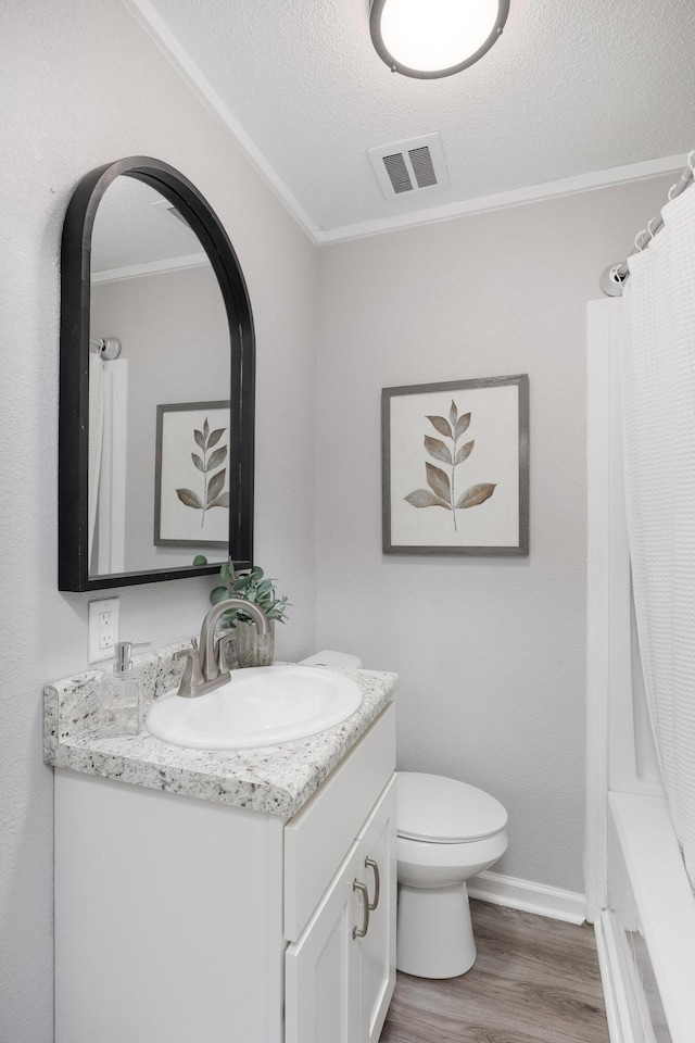 1852 N Prairie Cir, Hixson, TN 37343 - bathroom featuring wood finished floors, vanity, toilet, baseboards, and a textured ceiling