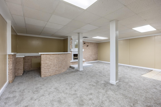 1852 N Prairie Cir, Hixson, TN 37343 - below grade area featuring carpet, a fireplace, brick wall, a paneled ceiling, and baseboards