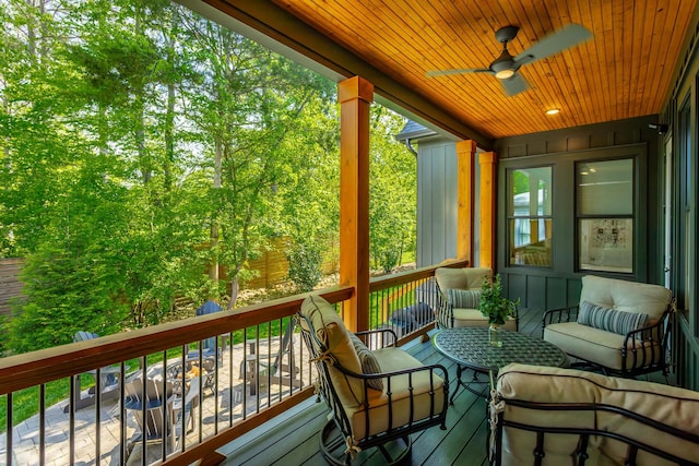 sunroom / solarium with ceiling fan and an outdoor hangout area