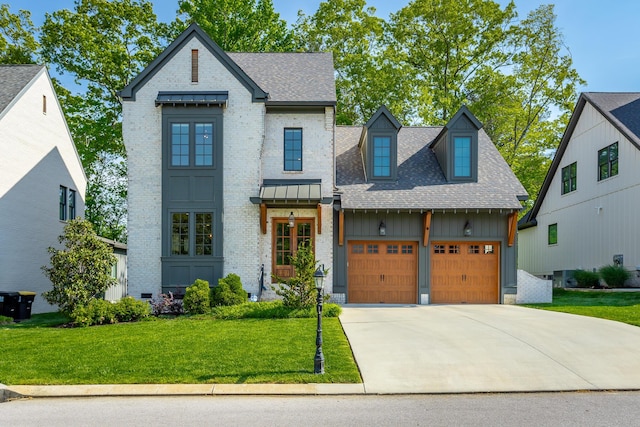 view of front of home with driveway, a front yard, brick siding, an attached garage, and a shingled roof