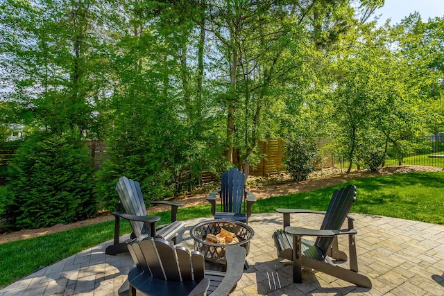 view of patio with a fenced backyard and a fire pit