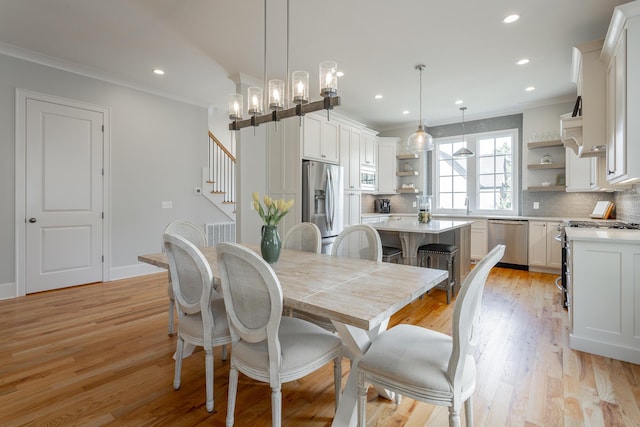 dining room featuring visible vents, stairway, ornamental molding, recessed lighting, and light wood-style flooring