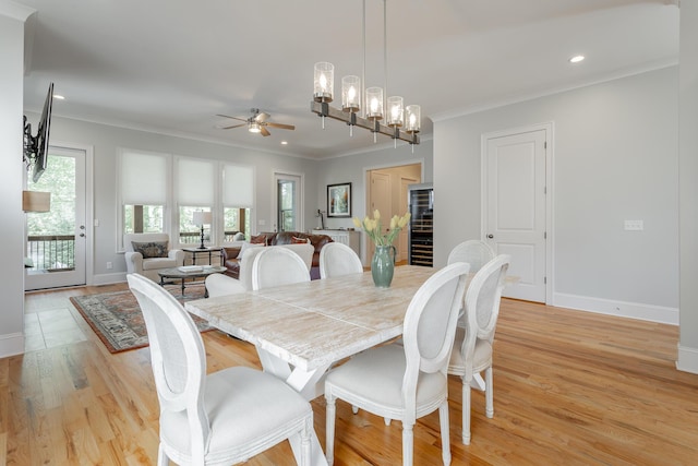 dining room featuring recessed lighting, baseboards, ornamental molding, and ceiling fan with notable chandelier