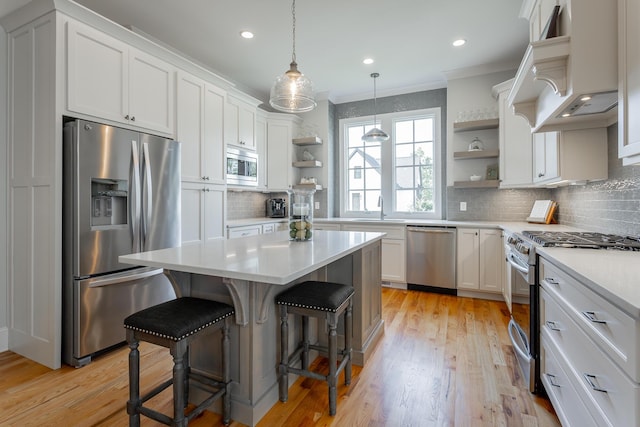 kitchen featuring a sink, appliances with stainless steel finishes, decorative backsplash, and open shelves