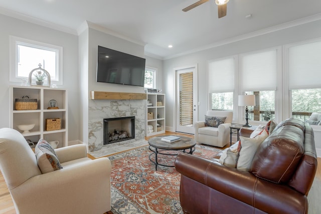 living room featuring crown molding and plenty of natural light