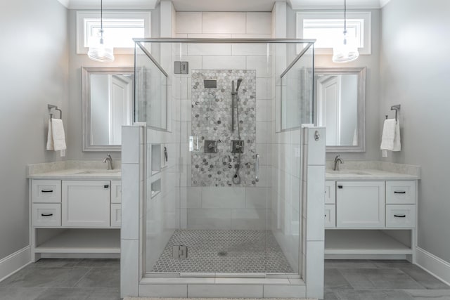 full bathroom featuring baseboards, a sink, and a shower stall