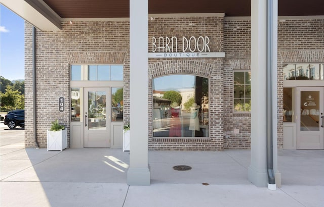 view of exterior entry with brick siding