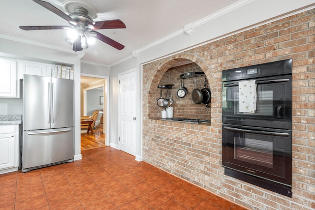 kitchen featuring ceiling fan, dobule oven black, white cabinets, freestanding refrigerator, and ornamental molding