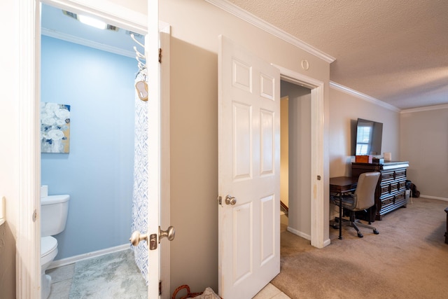 carpeted office with baseboards, ornamental molding, and a textured ceiling