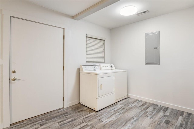 laundry room with laundry area, electric panel, independent washer and dryer, visible vents, and light wood finished floors
