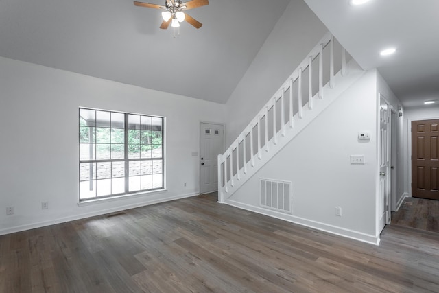 unfurnished living room with ceiling fan, baseboards, wood finished floors, visible vents, and stairway