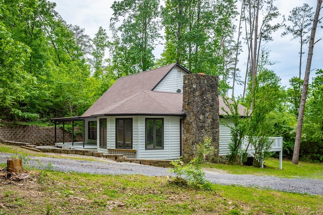 view of front of home with a porch and roof with shingles